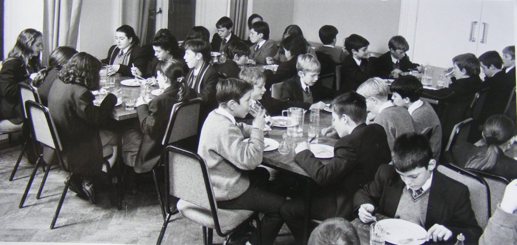 A group of students dining in a hall at Murlough House